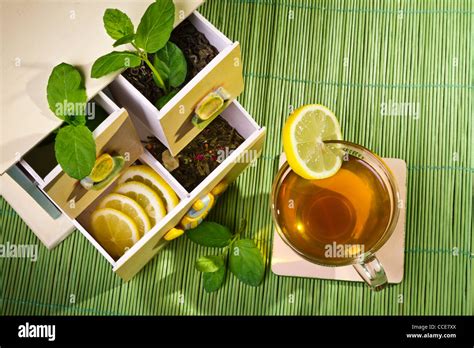 Hot Cup Of Tea And Cupboard On Bamboo Mat Stock Photo Alamy
