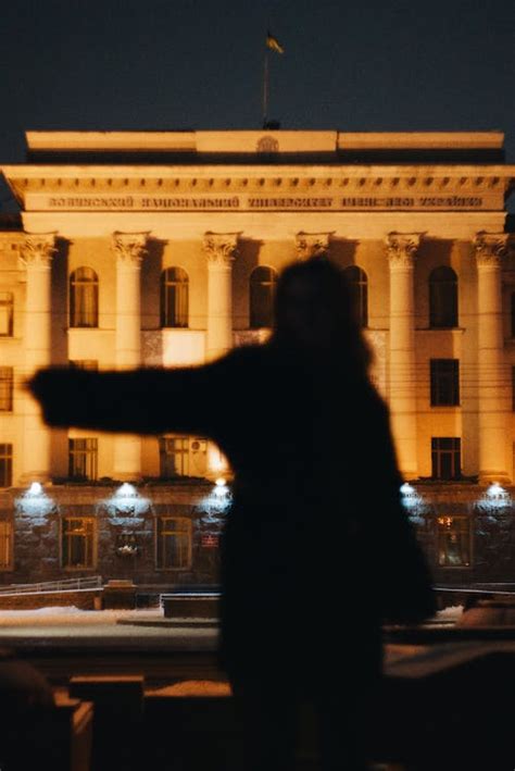 Woman Silhouette in front of Building at Night · Free Stock Photo