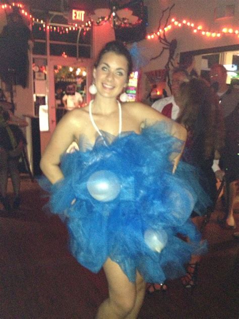 a woman in a blue costume is posing for the camera