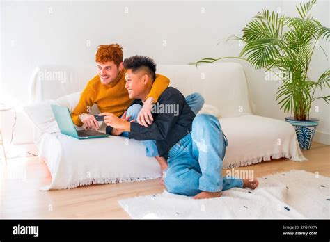 Beautiful Gay Couple Being Romantic On The Sofa Hugging Lgbt Concept
