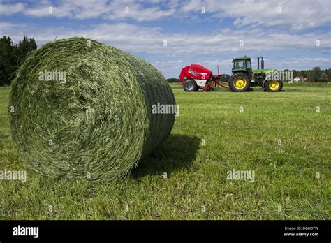 Round Silage Bale With John Deere Tractor And Welger Baler