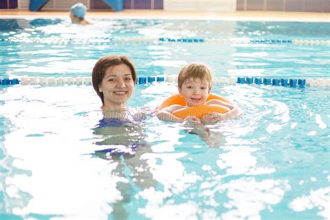 Mother and Baby Swim in the Pool. Healthy Family Mother Teaching Baby ...