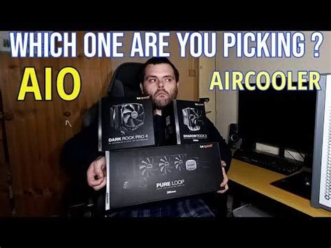 A Man Sitting In Front Of A Computer Holding Two Boxes With The Words