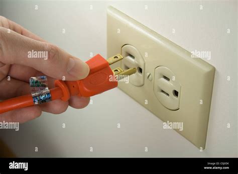 Hand Plugging Power Cord Into Wall Outlet Electrical Stock Photo Alamy