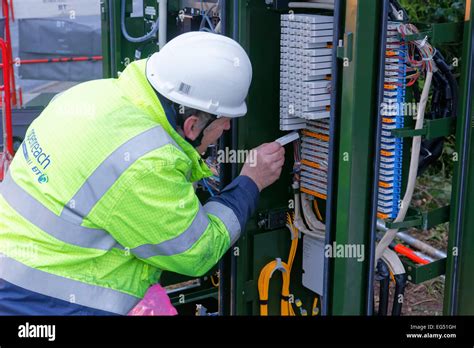 Bt Openreach Engineer Working On A Broadband Internet Fibre Cabinet In