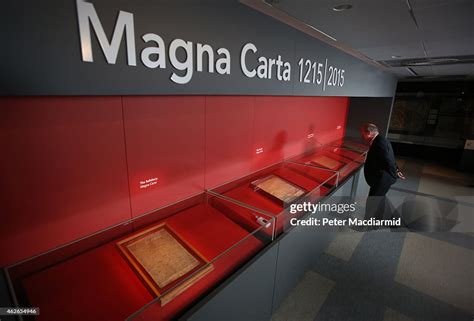 A visitor looks at one of the four copies of the Magna Carta on... News ...