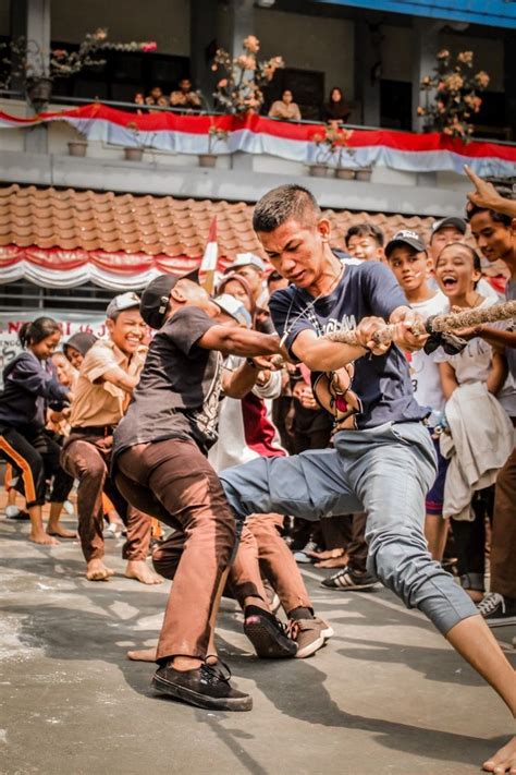 Two Men Fighting Each Other In Front Of A Crowd