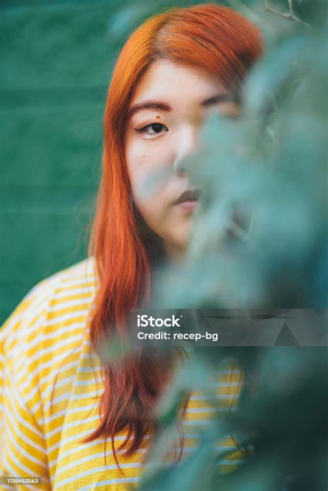 Portrait Of Millennial Generation Young Woman Wearing Yellow Tshirt In