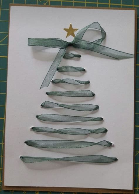 A Christmas Tree Made Out Of Ribbon On Top Of A Piece Of Paper