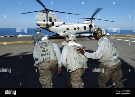 Us Navy Combat Cargo Crew Members Prepare To Assist With Offloading