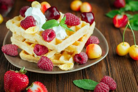 Belgian Waffles With Berries Whipped Cream And Grated Chocolate Stock