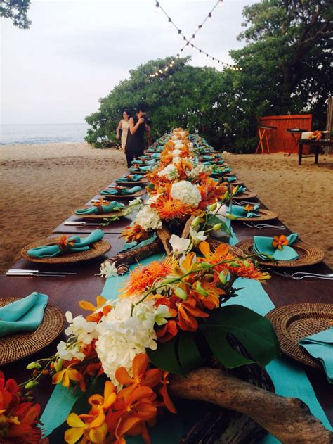 A Long Table Is Set Up On The Beach For An Outdoor Dinner Party With