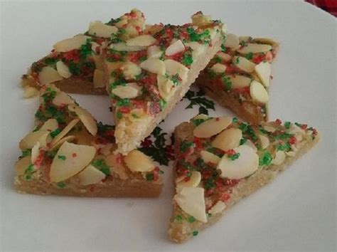 Several Pieces Of Food On A Plate With Sprinkles And Nuts In The Middle