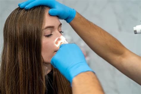 Premium Photo Ent Doctor Examines The Patient S Nose Using An