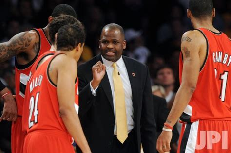 Photo: Blazers coach Nat McMillan calls a play during a timeout against ...