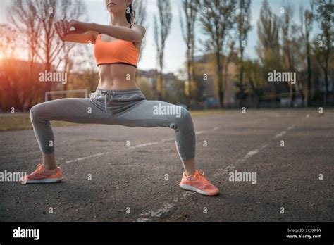 Attractive Brunette Woman Warm Up And Stretching In Park At Sunshine Stock Photo Alamy
