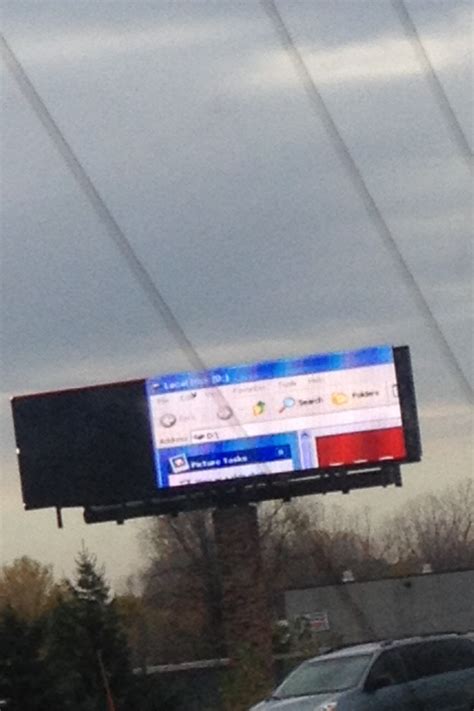 A Large Billboard In The Middle Of A Parking Lot