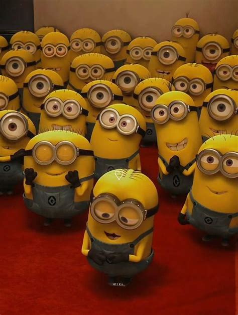 a group of minion characters standing on a red carpet