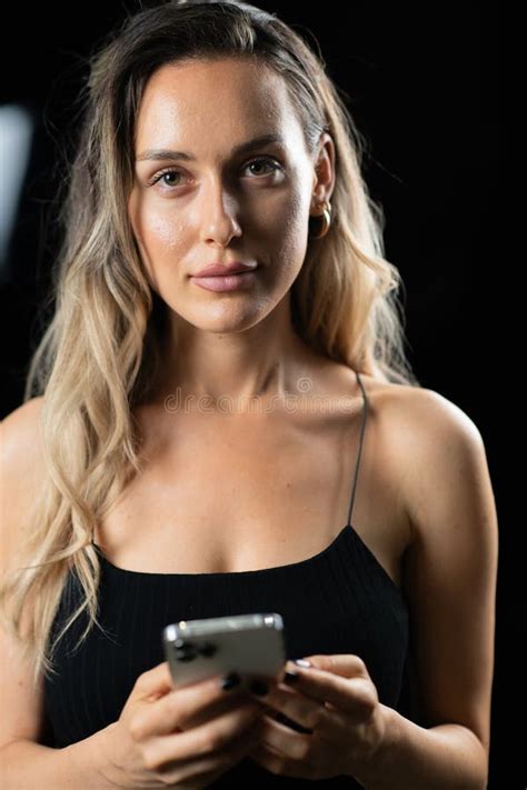 Blonde Woman Black Dress Posing Elegantly Studio Background Holding Smartphone Her Hands Stock