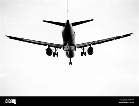 A Black And White Landscape Format Image Taken From Underneath A Jet