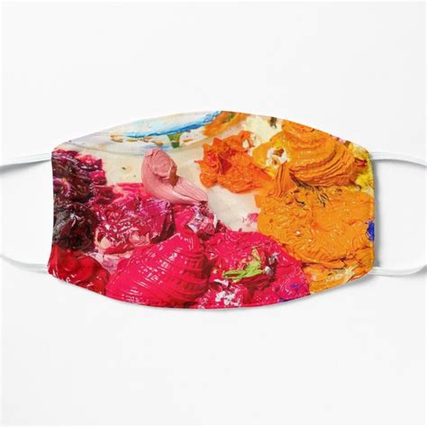 A Face Mask With An Image Of Colorful Flowers On The Front And Side