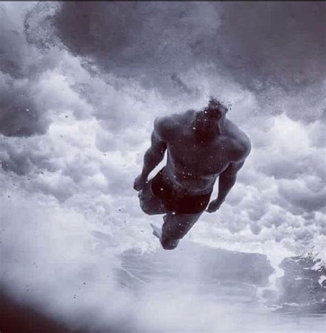 A Man Is Swimming In The Ocean Under A Cloudy Sky