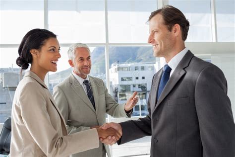 Businessman Introducing A Colleague Stock Photo Image Of Coworkers