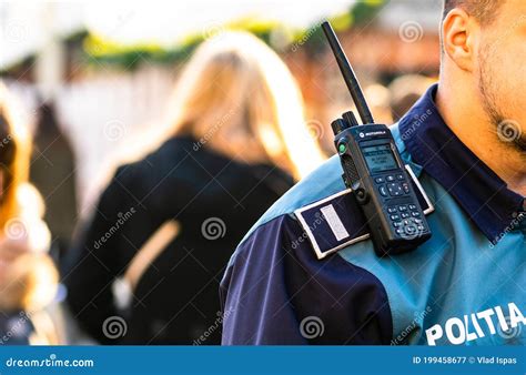 Police Officer Holding Walkie Talkie on His Shoulder during ...