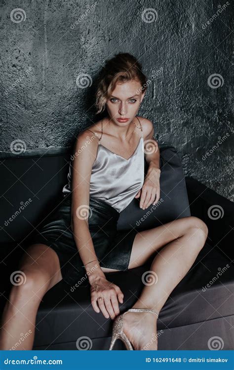 Portrait Of A Beautiful Fashionable Blonde Woman In A Black Skirt Stock