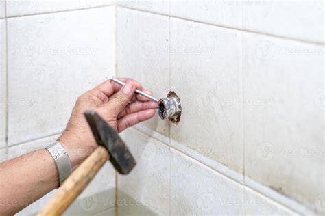 Asian man tries to fix and repair pipe shower in the old restroom ...