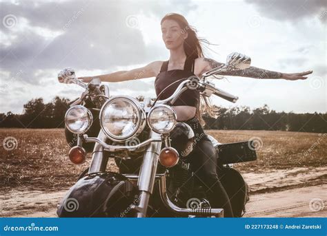 Portrait Of A Young Beautiful Girl Riding A Motorcycle With Outstretched Arms Motor Sport