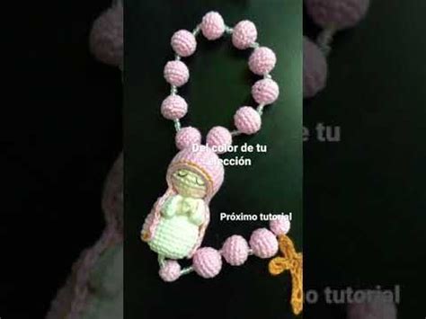 A Crocheted Beaded Necklace With An Image Of A Baby Doll On It