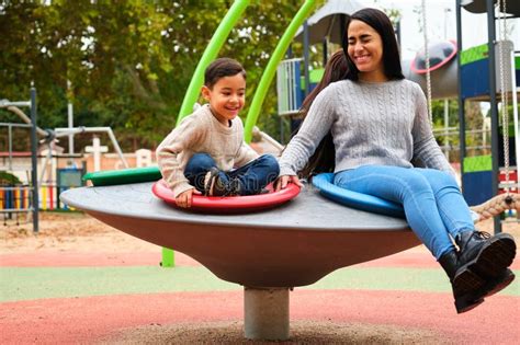 Lesbian Couple Laughing While Playing With Their Son In The Playground Stock Photo Image Of
