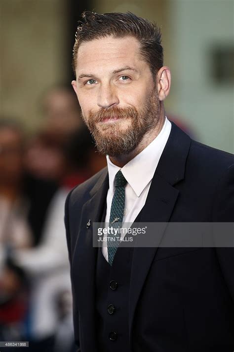 British Actor Tom Hardy Poses For Pictures On The Red Carpet After