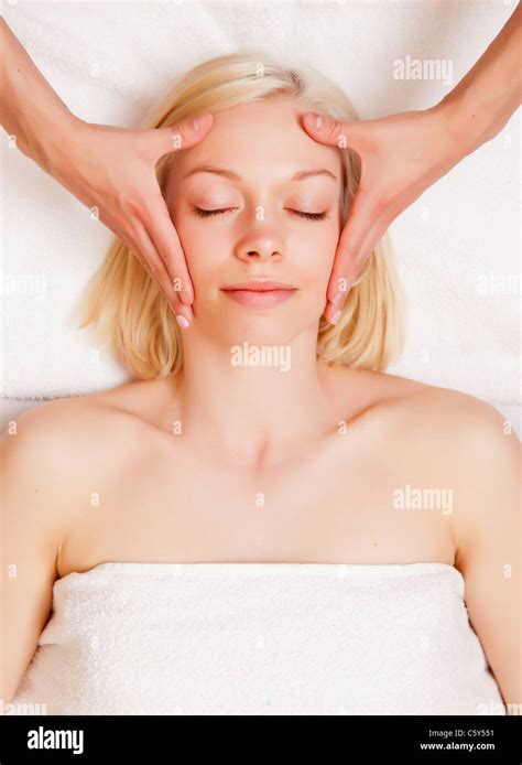 A Beautiful Blonde Woman Receiving A Stress Reducing Head Massage At A