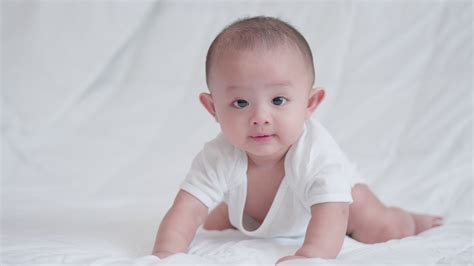 Happy family, Cute Asian newborn baby boy lying play on white bed look ...