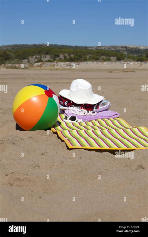 Beach Scene In The Summer With Beach Ball Towel Sunglasses And Straw