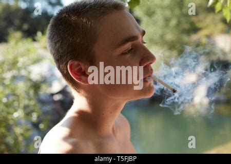 Teenage boy smoking Stock Photo - Alamy