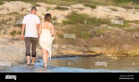 Happy Romantic Middle Aged Couple Enjoying Beautiful Sunset Walk On The