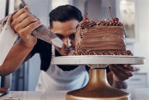 Piping Chef And Man Baker Baking A Cake With Chocolate In A Kitchen Or