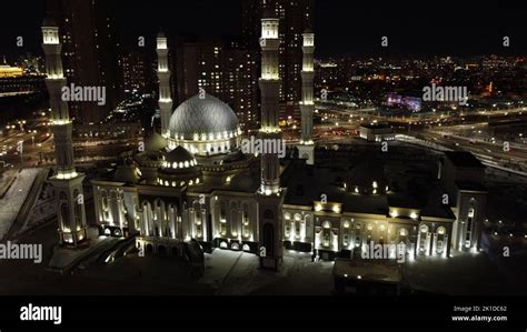 The aerial view of an illuminated mosque in Nur-Sultan City at night ...