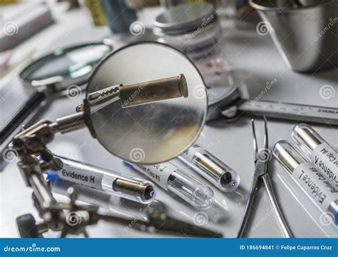 Scientific Police Examining A Bullet Cap In Ballistic Laboratory Stock