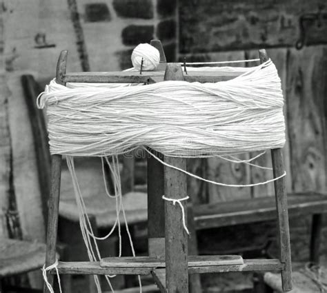 Antique Wooden Spinning Wheel With The Skein Of Wool Below And T Stock