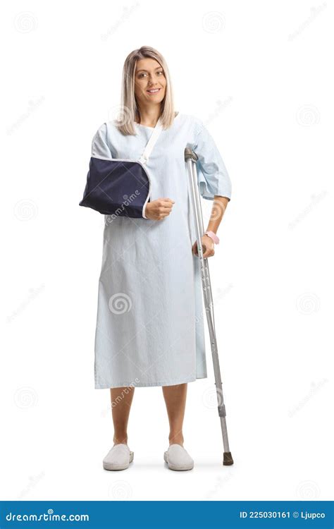 Full Length Portrait Of A Young Female Patient With A Broken Arm And A