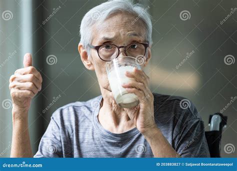 Asian Senior Woman Drinking Fresh Milk From The Glass Old Elderly