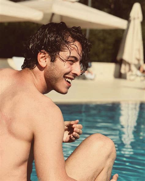 A Man Sitting On The Edge Of A Swimming Pool