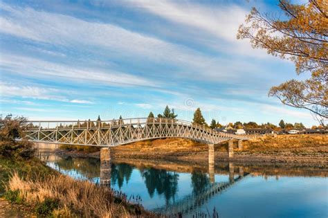 Arch Bridge Over Lake Tekapo In Autumn Forest At New Zealand Stock