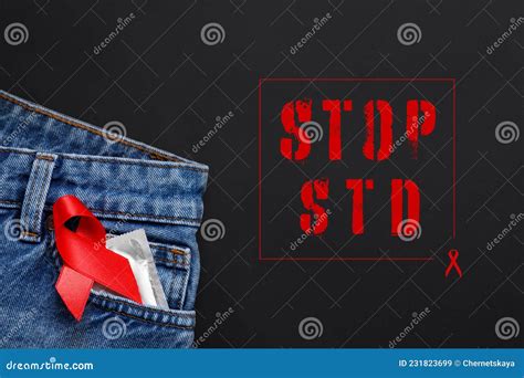 Jeans With Condom And Red Ribbon In Pocket On Black Background Top