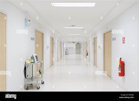 Vital signs patient monitor and fire extinguisher placed on corridor of ...