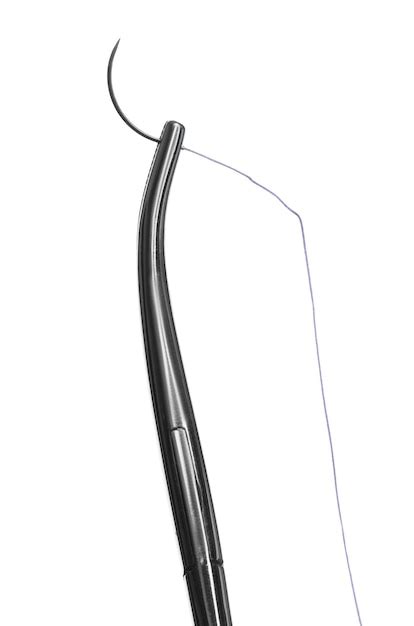 Forceps avec fil de suture sur fond blanc Matériel médical Photo Premium